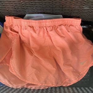Coral Nike running shorts